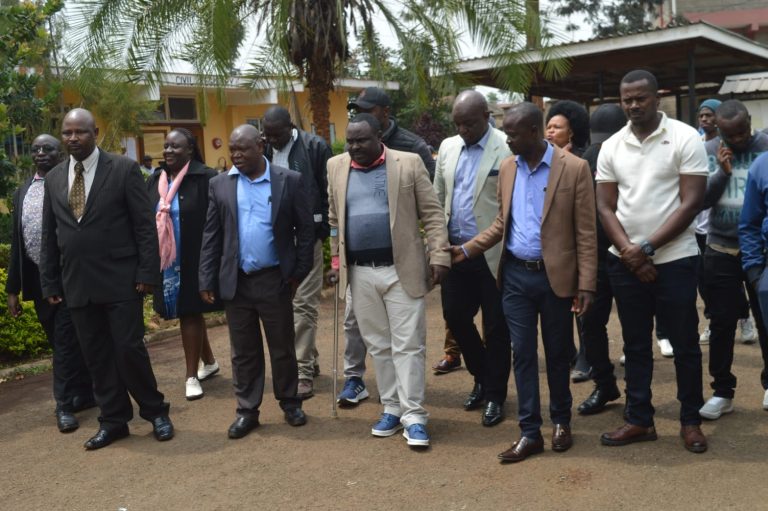Nelson Munga MCA Ndeiya (in walking sticks) being accompanied by fellow MCAs in Kiambu law courts yesterday.