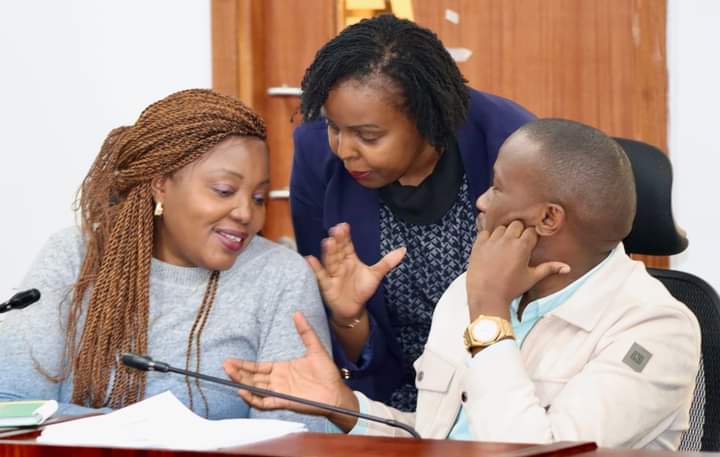 Nyeri County Women Representative Rahab Mukami (left) consulting with her colleagues during the Saturday forum