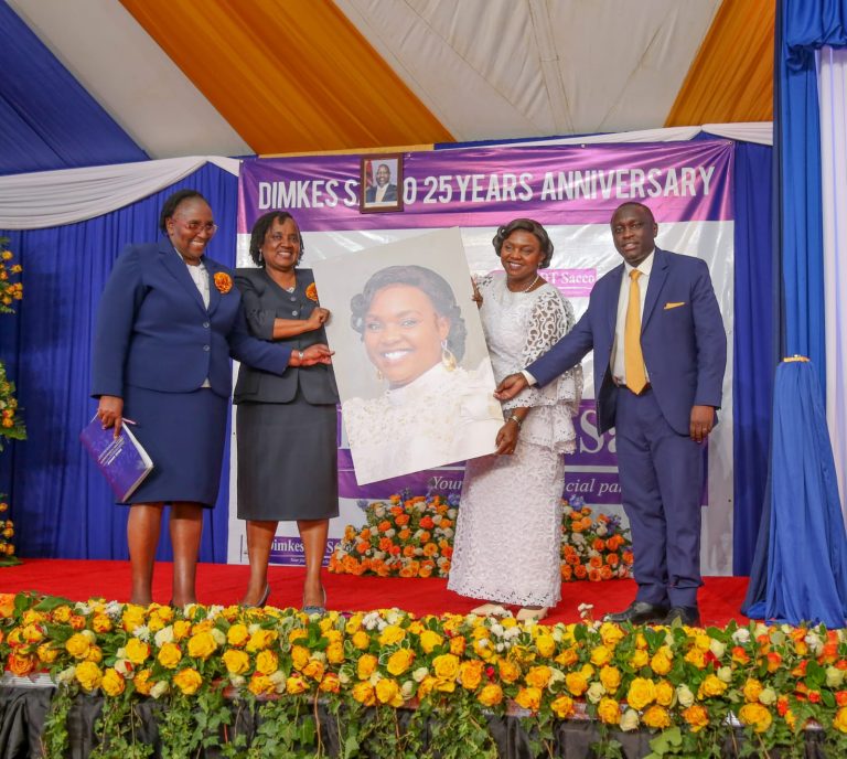 Pastor Dorcas Rigathi (in white) receives a photo gift during 25th Anniversary celebrations for Dimkes DT Sacco, and launch of Dimsure Insurance Agency at the St Paul ACK Church Grounds on Friday 19th July 2024 from DIMKES CEO Benson Maina (on her left), Sacco Chairlady Caroline Gikonyo and Rev Esther Kagicha. Photo/ODP