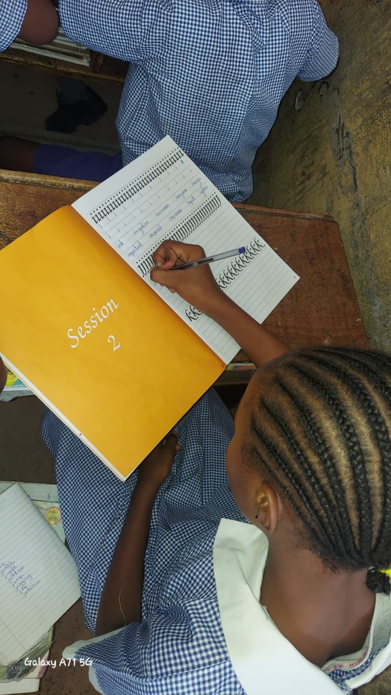 Pupils practice handwriting during the Express Myself With BIC handwriting session in the classroom.