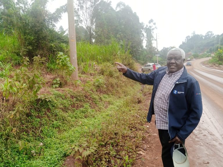 Fredrick Mburu pointing at the piece of land. Photo/Felix Njenga
