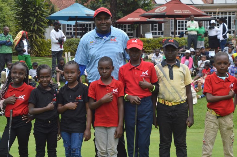 Michael Karanga (in Blue Shirt with young golfers at kiambu Golf Club