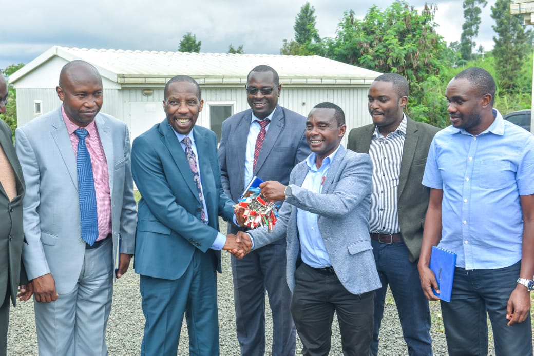 National Irrigation Authority Chief Executive Officer Eng. Charles Mwasia (3rd right) handing over keys to Kirinyaga County Deputy Governor David Githanda.