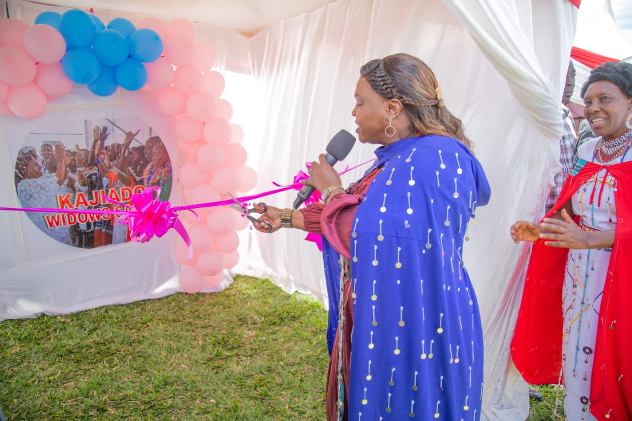 Pastor Dorcas Rigathi cuts the ribbon during the launch of the Loitokitok Widows Sacco on Thursday at Kimana Ward in Kajiado South during a widows empowerment meeting.