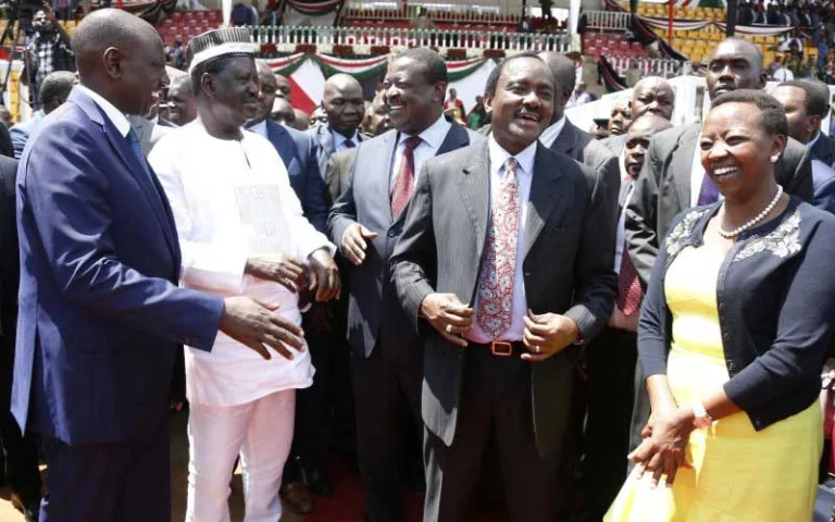 President William Ruto in a conversation with former PM Raila Odinga, former VPs Musalia Mudavadi and Kalonzo Musyoka flanked by Rachel Ruto during the Mashujaa Day celebration in 2018. (File)