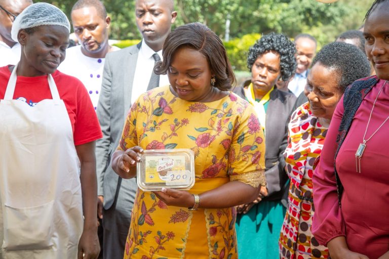 The spouse of the Deputy President Pastor Dorcas Rigathi looks at the packaged deep fried omena by widows from Kibra slum and environs who are part of the Widows and Orphans program she launched more than one year ago. The widows have become empowered and have a tree nursery with more than 125,000 tree seedlings, are repackaging cereals, engaged in small business, and other economic projects. Photo/DPC