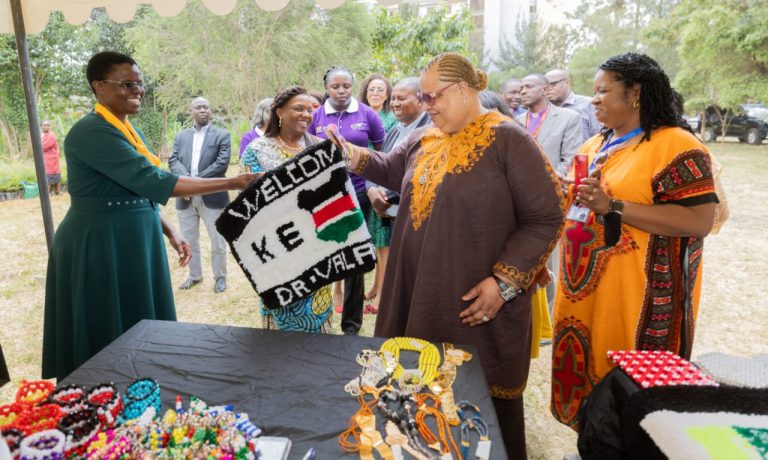 Dr Valerie Daniels-Carter receives a mat made specially for her by Kibra Widows Group welcoming her to Kenya yesterday at the House of Grace, Nairobi West