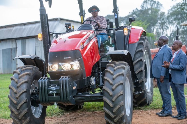 Eglyne Chepchirchir Choge starts the engine of the newly acquired tractor. Looking on is Rift Valley Regional General Manager Stanley Nga’ng’a (left) and Michael Chege (right), the Branch Growth and Development M