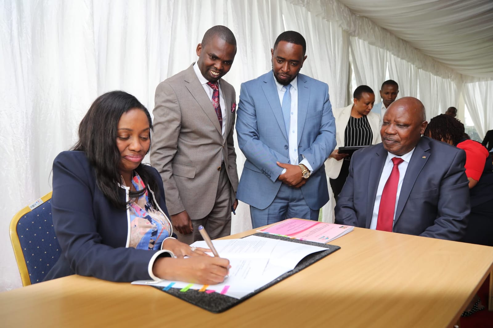 Governor Susan Kihika appends her signature while overseeing the signing of RRI performance contracts.