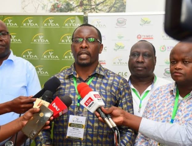 KTDA chairman Enos Njeru addressing the media as the agency CEO Wilson Muthaura and vice-chairman Eric Chepkwony listens