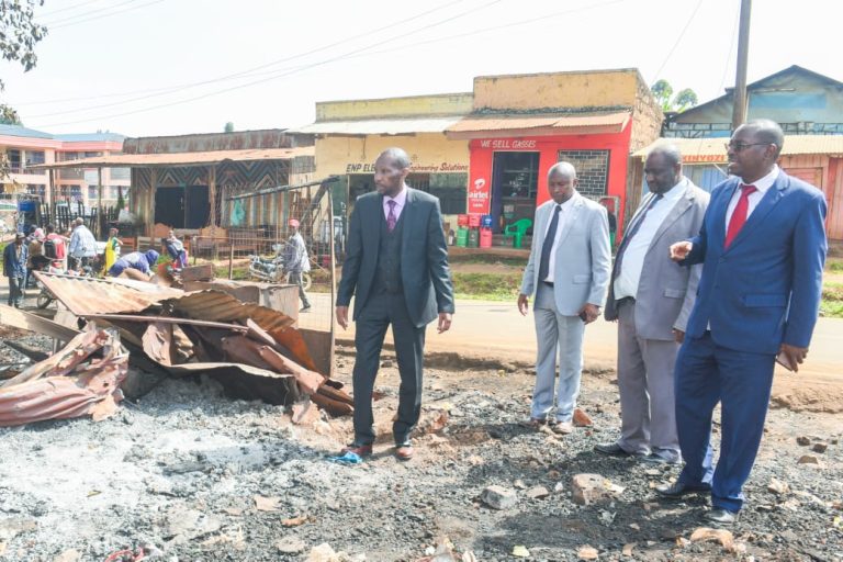 Kirinyaga County Deputy Governor David Githanda with other officials at the fire Incident site yesterday.