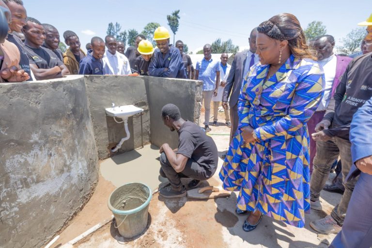 Pastor Dorcas Rigathi, the spouse of the DP watches as one of the beneficiaries of the boy child program in Ngorano, Nyeri County on Friday