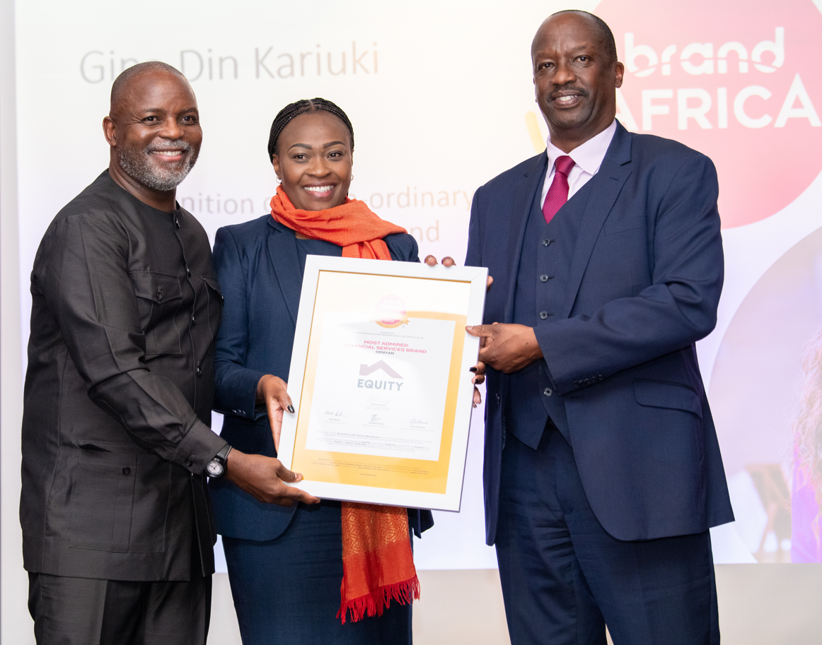 Pauline Mwatu (centre), Equity Group Head of Research and Analytics, receives the certificate of recognition awarded to Equity Bank during the Brand Africa 100