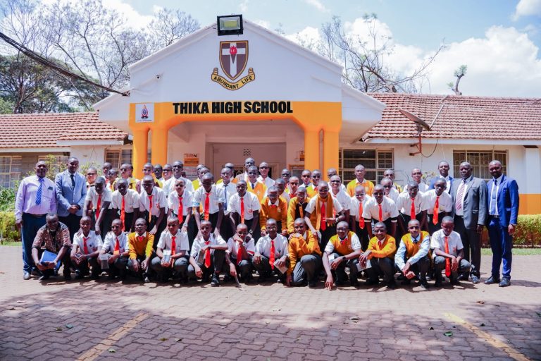 Thika High School students who received medical eyeglasses to correct sight challenges outside the school office yesterday, together with their Chief Principal Julius Muraya.