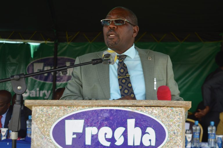 George Kinyanjui Githunguri dairy farmers cooperative society board chairman speaking during the annual general meeting held in Githunguri stadium.