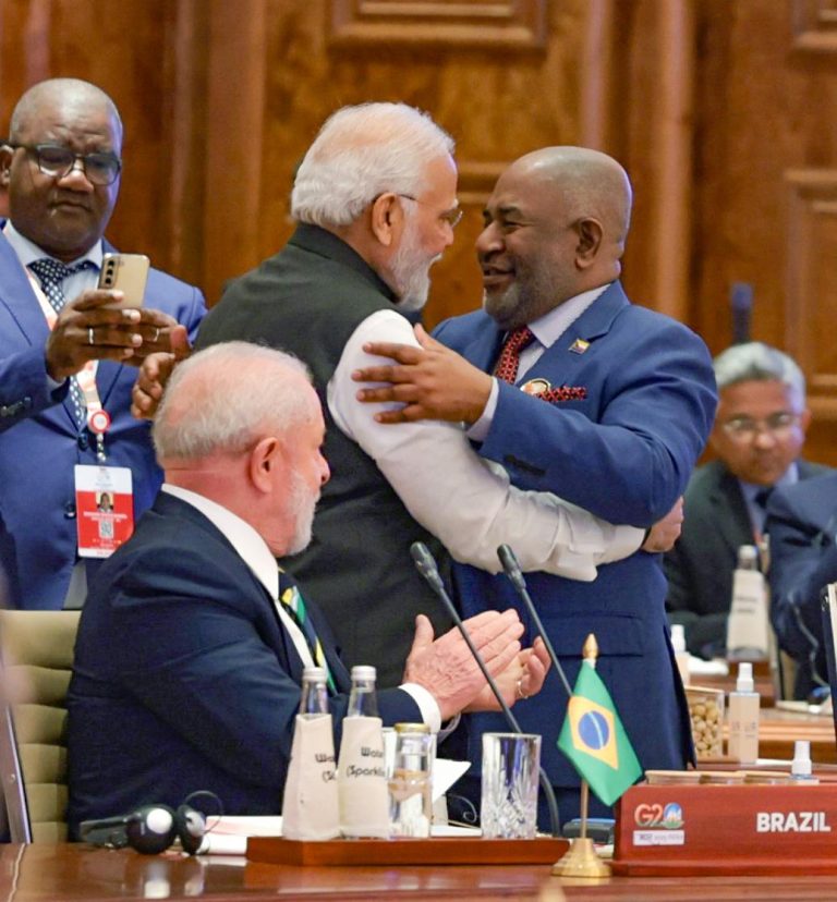 India's Prime Minister Narendra Modi shares a light moment with former African Union Chairman and Comoros President Azali Assoumani during the G20 Leaders' Summit in New Delhi, Sept 9, 2023