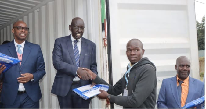 Education Principal Secretary Belio Kipsang handing over examination papers in Dagoretti yesterday.