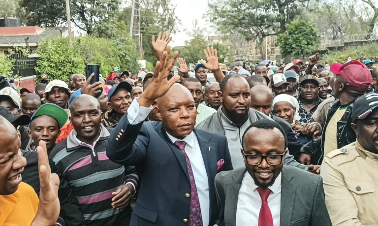 Maina Njenga waving his supporters as he left the Nakuru Law Courts yesterday.