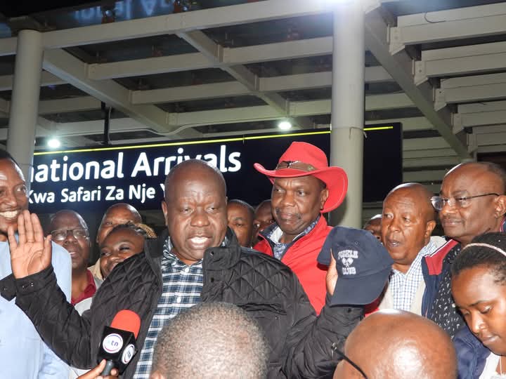 Former Interior Cabinet Secretary Dr Fred Matiang' being received at Jomo Kenyatta International Airport by leaders led by Jubilee party Secretary General Jeremiah Kioni