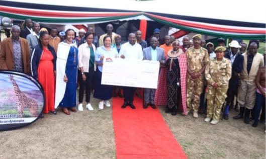 Deputy President Prof Kithure Kindiki with Cabinet Secretary Rebecca Miano and other stakeholders while issuing compensation cheque at Naibor, Laikipia county last week