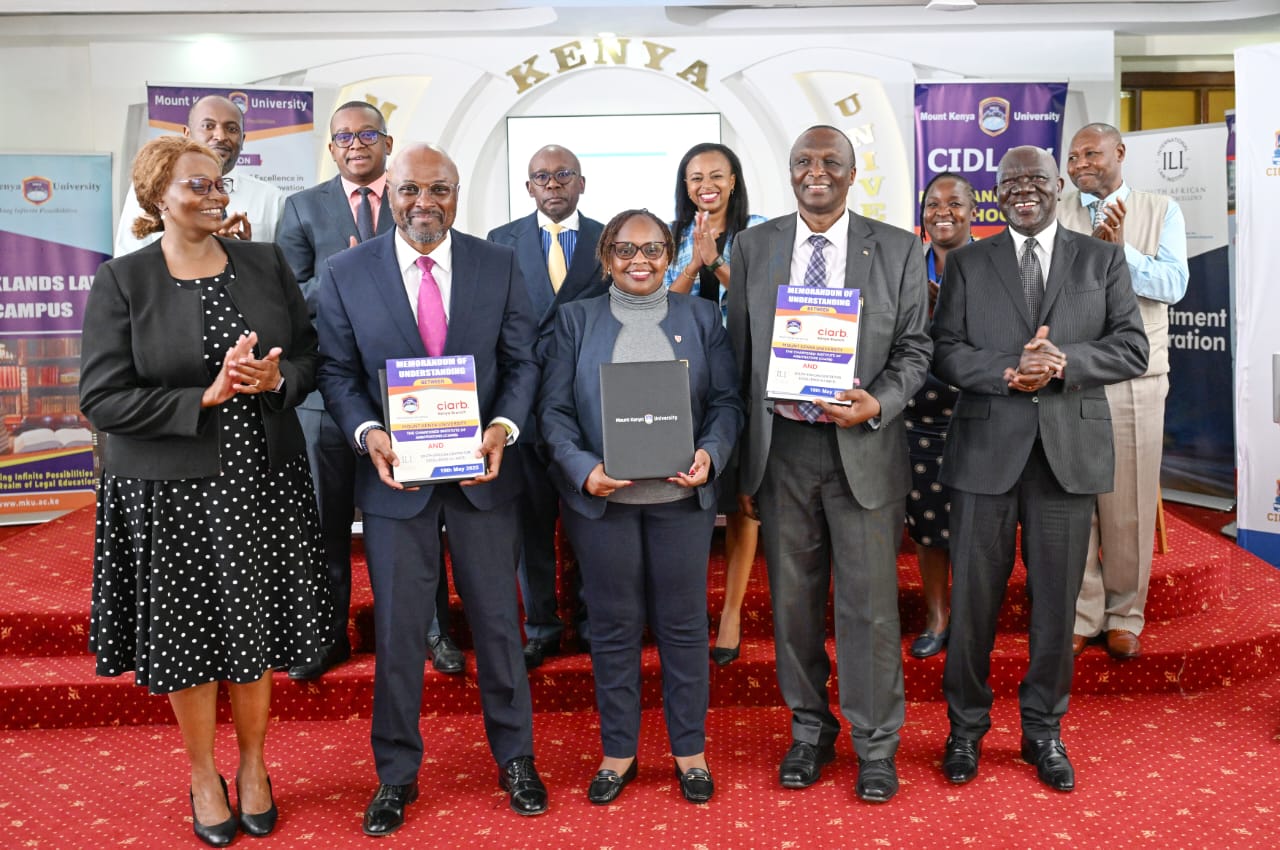Parties displaying their MoU documents after the signing ceremony.
