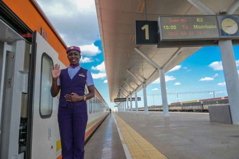 A conductor waits for passengers by a train to Mombasa at Nairobi Terminus Station of the China built Mombasa-Nairobi Standard Gauge Railway (SGR) in Nairobi.