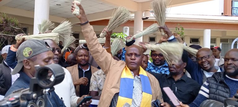 Kenya National Congress party Leader Atati Kengele (with yellow and blue scarft) speaks at Meru slopes Hotel yesterday. (2)