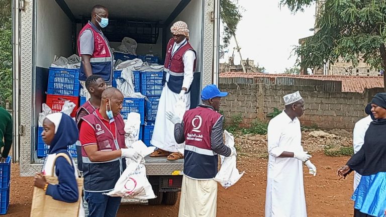 Kibera residents receive meat donations from a Qatar Charity representative in Nairobi on Friday.