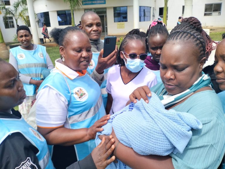 Tharaka Nithi County Children and Gender Chief Officer Ms Karimi Rwigi holds a baby found abandoned in a thicket.