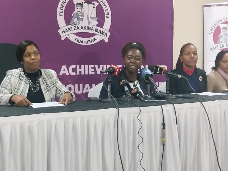 FIDA-Kenya Chairperson Christine Kungu issuing her statement to the press alongside FIDA representatives.