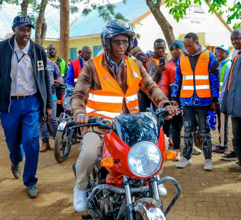 Ruiru MP Simon King'ara riding one of the new motorbikes delivered to Ruiru Boda Boda groups by the government to boost their business.