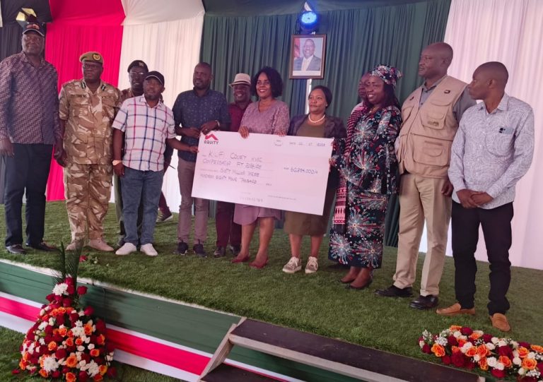 Wildlife Cabinet Secretary Rebecca Miano and other stakeholders during the handing over of the compensation cheque.