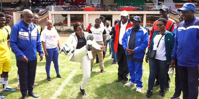 Embu County governor Cecily Mbarire kicking a ball to officially launch KECOSO Games.