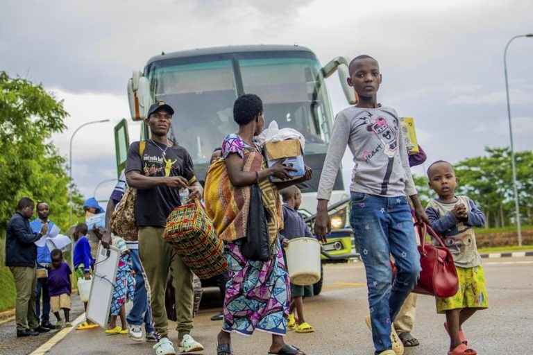 Burundian refugees to be repatriated disembark a bus at the Nemba-Gasenyi border post between Rwanda and Burundi, on Nov. 25, 2025.