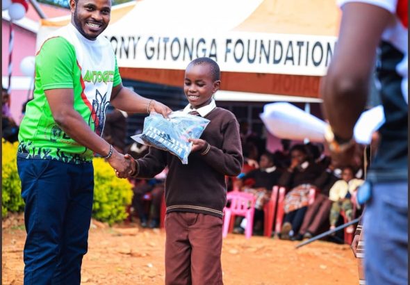 Antony Gitonga gifting a pupil in the past.