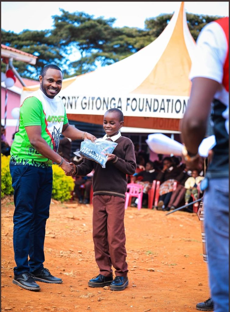 Antony Gitonga gifting a pupil in the past.