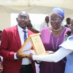 Elder Jane Kamutu (2nd right) receiving a present alongside her husband Joseph Kamutu (2nd right).