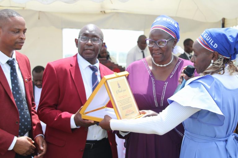 Elder Jane Kamutu (2nd right) receiving a present alongside her husband Joseph Kamutu (2nd right).