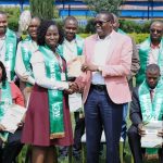 Optiven limited CEO George Wachiuri presenting a certificate to one of the graduates of a past cohort.