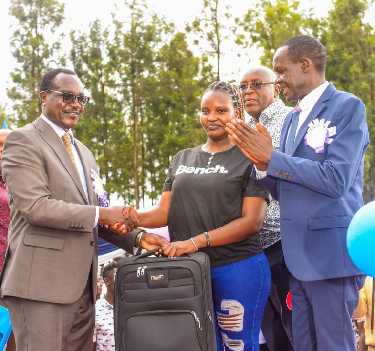 CS Education Julius Ogamba Migos, Gianchere Senior Secondary School Principal Dr Philip Ochoi during the award ceremony