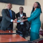 MMV Associates CLG Chief Executive Officer Ms Emmah Kasis handing over a document to lawyer Victor Ombongi yesterday.
