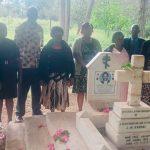 Some of MMV Associates CLG members and JM Kariuki's wife at his graveside.
