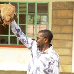 Dr Patrick Bucha hold a hen at the Nchaure Primary and Junior School Fundraiser.