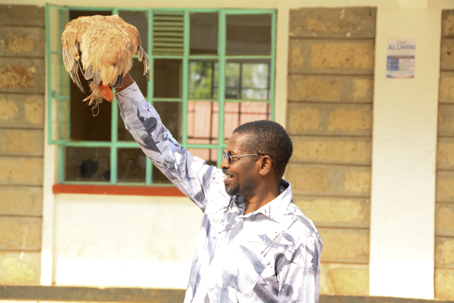 Dr Patrick Bucha hold a hen at the Nchaure Primary and Junior School Fundraiser.
