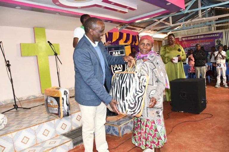 Eng. Wangai Ndirangu with one of the beneficiaries.