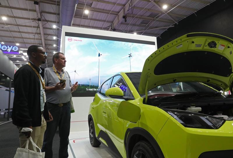 Visitors learn about a BYD vehicle during the Solar and Storage Live Africa 2026 in Johannesburg, South Africa, March 25, 2026.