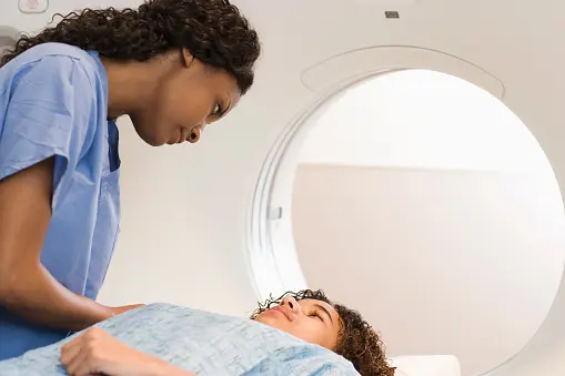 Photo 1 Paediatric Imaging =,,, A Black Briiush nurse gets a a white patient ready for imaging but many intolerant whites refused to be touched by non whites. Photo Courtesy SoR