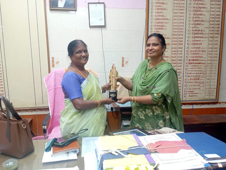 D. Brinda receives award from education officer.
