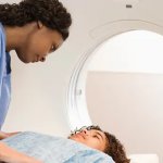 Photo 1 Paediatric Imaging =,,, A Black Briiush nurse gets a a white patient ready for imaging but many intolerant whites refused to be touched by non whites. Photo Courtesy SoR