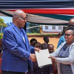 Governor Amos Nyaribo handing over employment letter to one of the officers on permanent and pensionable terms